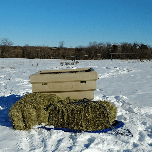 Hay Optimizer in winter surrounded by hay bales